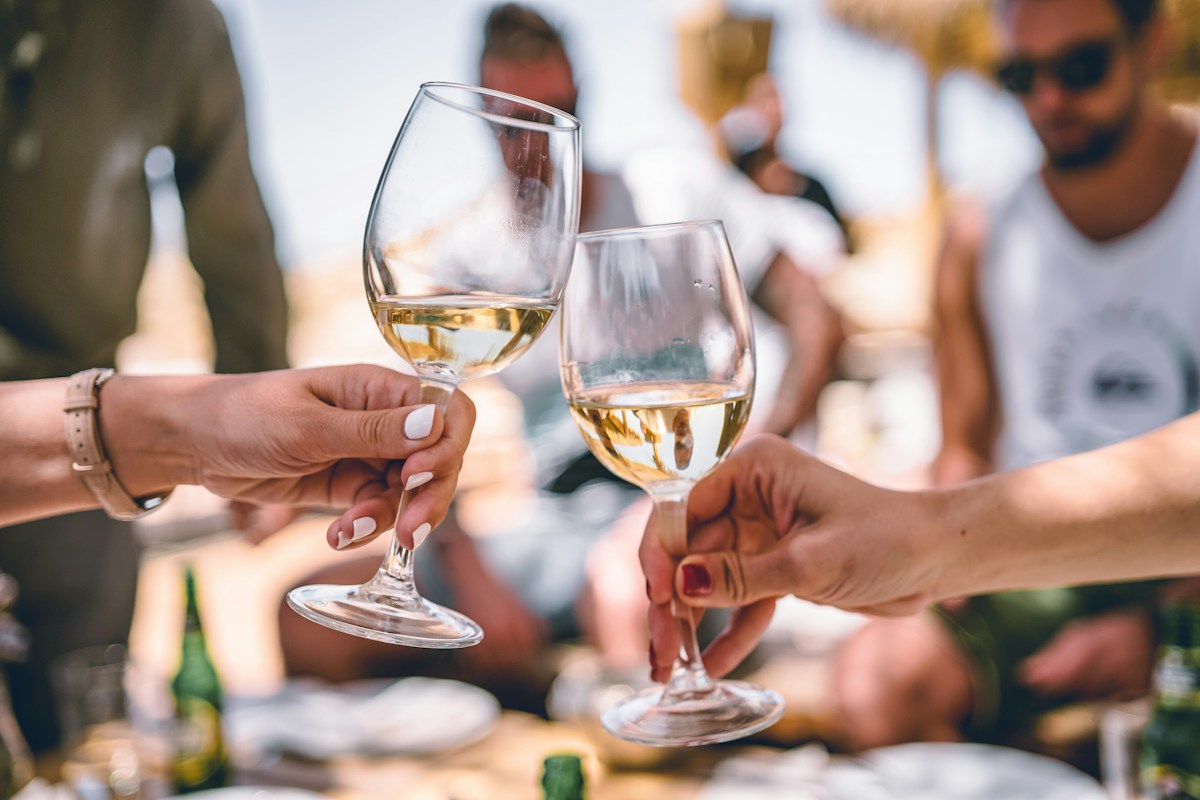 Two people toasting with wine glasses in celebration